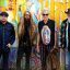 Atomic Rooster band members standing in front of colorful graffiti wall – live at The Cavern Club Liverpool, March 1st 2026