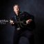 Billy Fury tribute artist performing live with acoustic guitar at the Cavern Club Liverpool