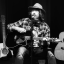 Ian McNabb performing live with acoustic guitar at the Cavern Club Liverpool